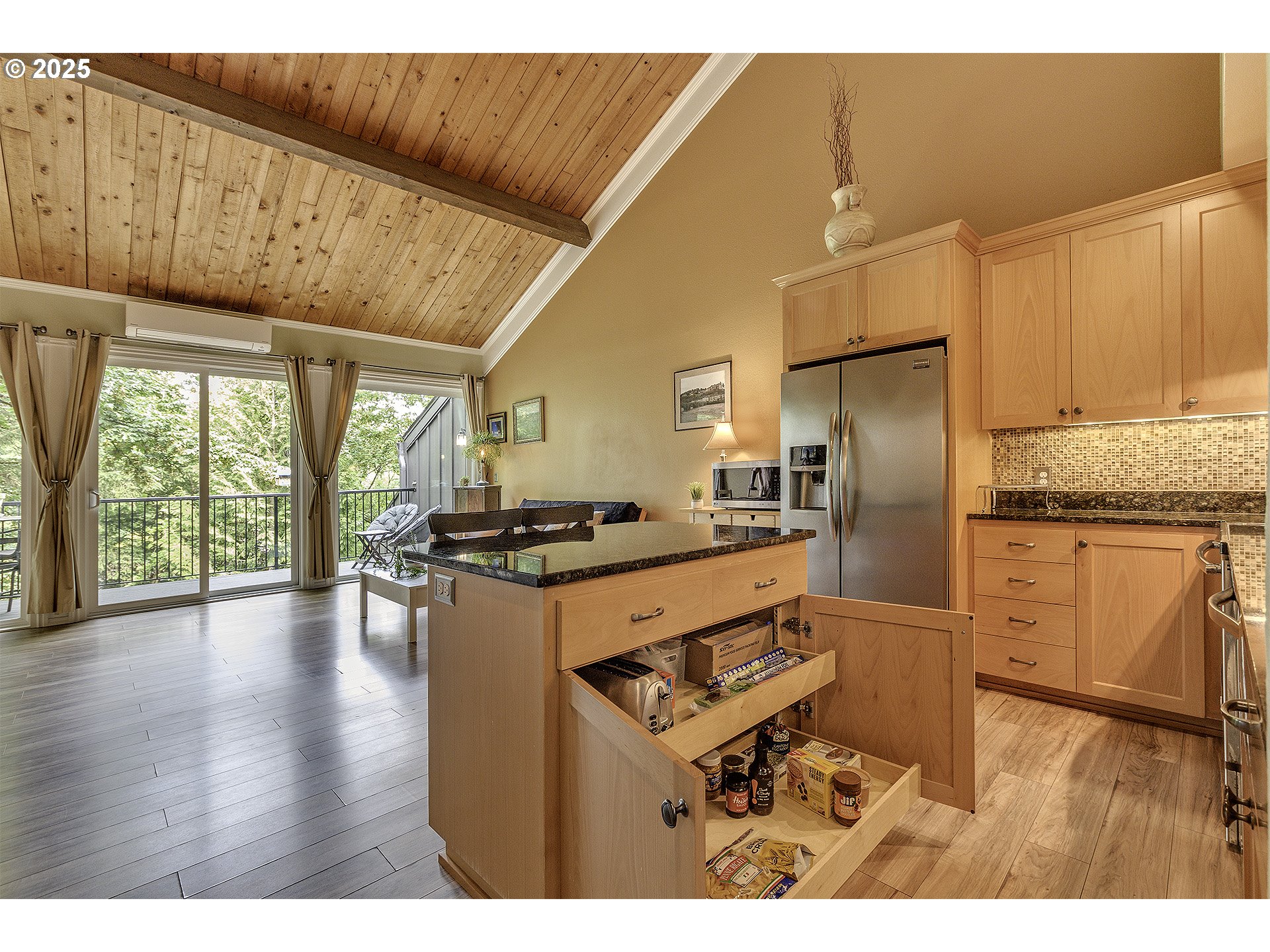 4 Touchstone, Unit 113 Lake Oswego, OR 97035 - Photo 8 of 32 a kitchen with kitchen island granite countertop a stove refrigerator and a microwave oven with large window