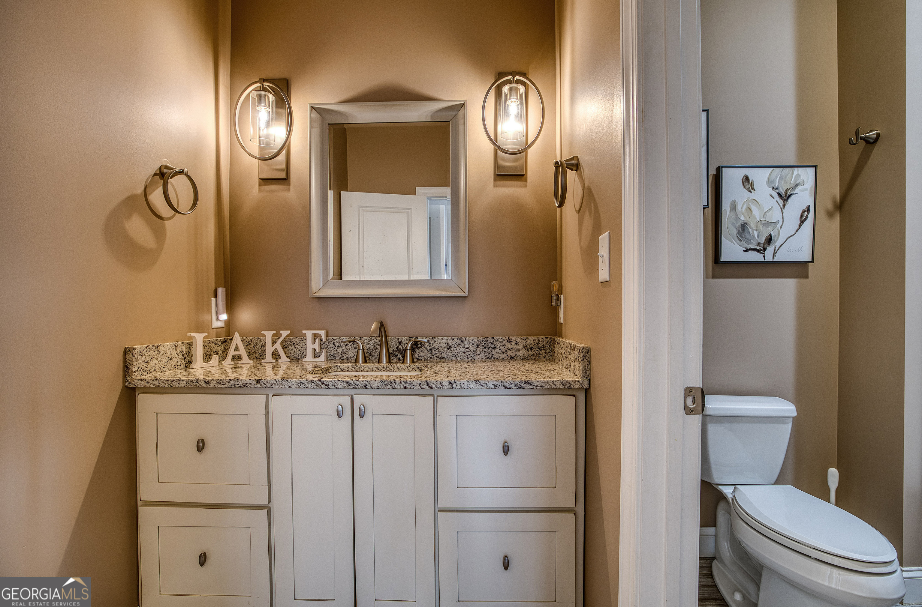112 Springhill Lane Clarkesville, GA 30523 - Photo 21 of 79 a bathroom with a toilet sink vanity and mirror