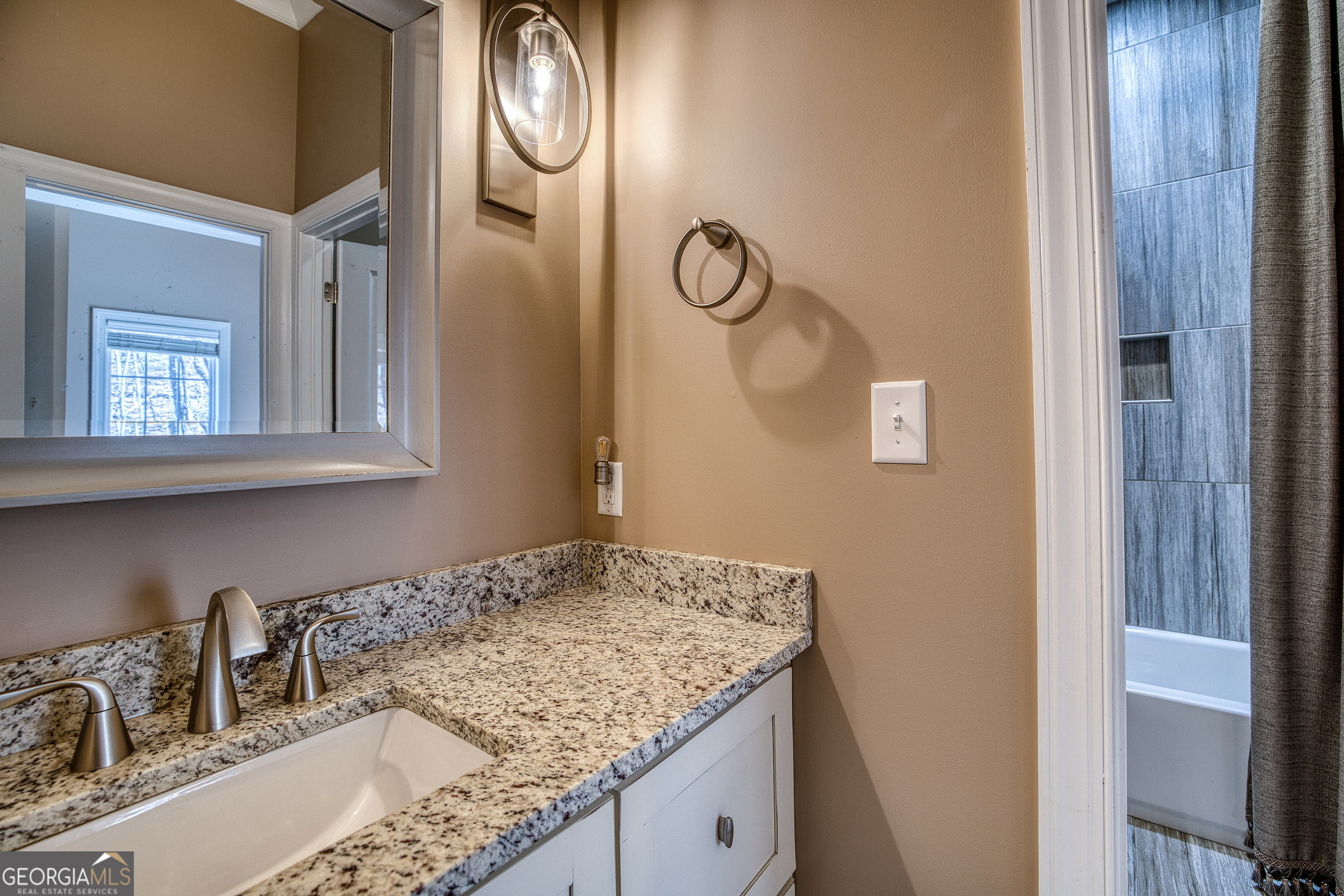112 Springhill Lane Clarkesville, GA 30523 - Photo 23 of 79 a bathroom with a granite countertop sink and a mirror