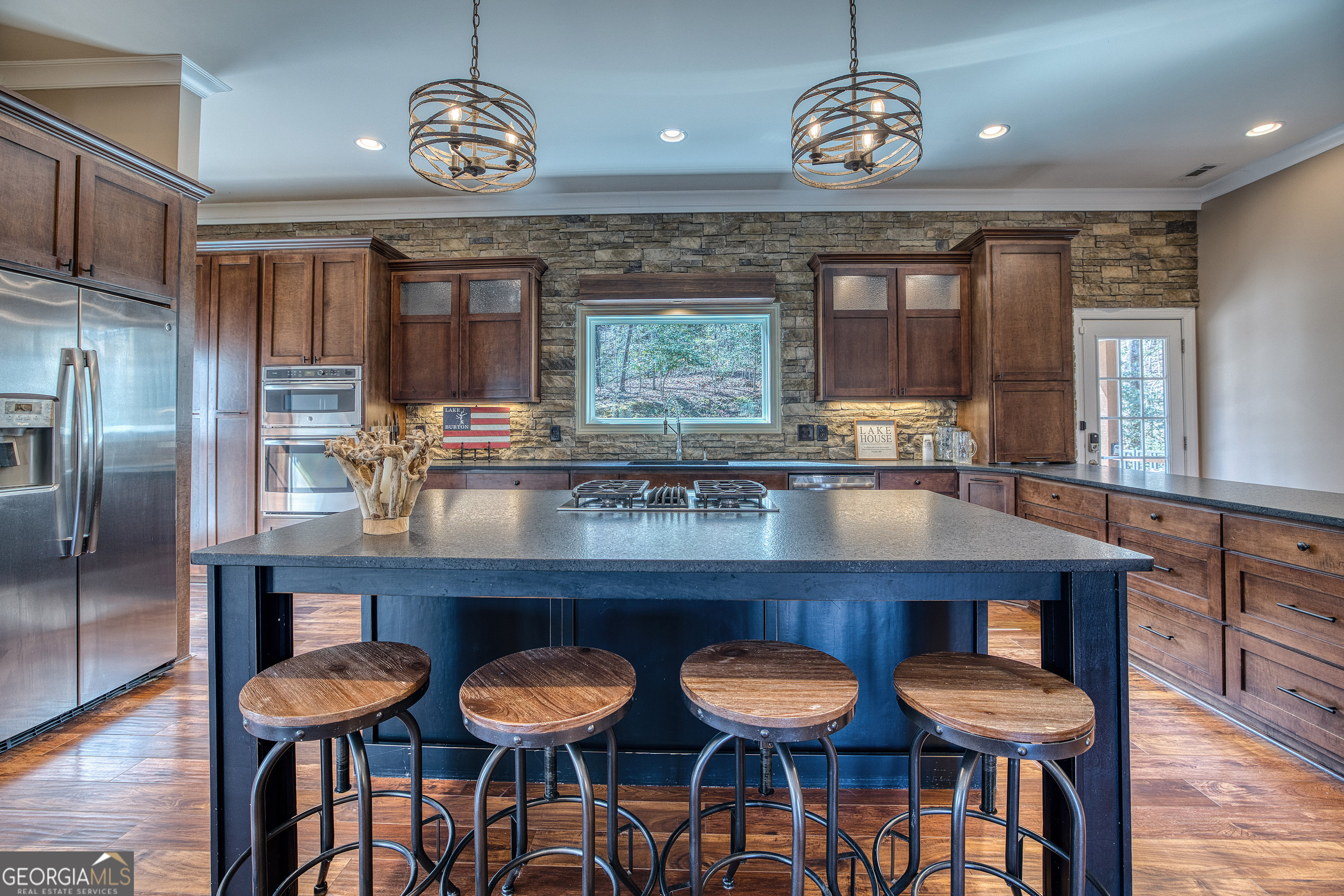 112 Springhill Lane Clarkesville, GA 30523 - Photo 7 of 79 a kitchen with stainless steel appliances granite countertop a dining table chairs cabinets and wooden floor
