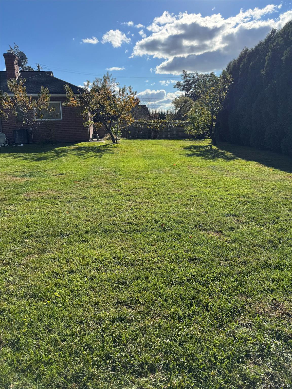 80 Dorset Road Scarsdale, NY 10583 - Photo 3 of 13 a view of a large pool with lawn chairs under an umbrella
