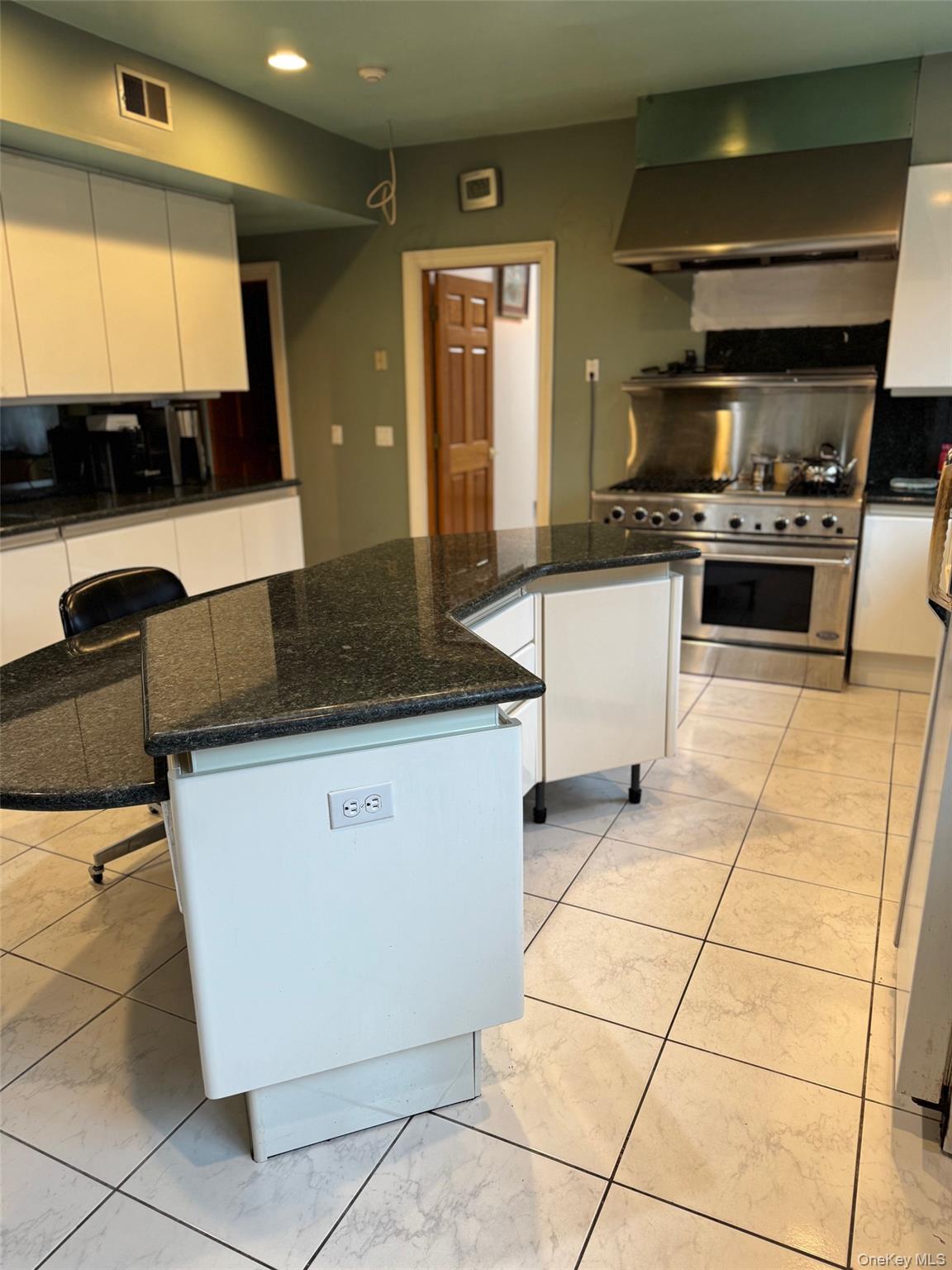 80 Dorset Road Scarsdale, NY 10583 - Photo 6 of 13 a kitchen with granite countertop a stove a sink and a microwave