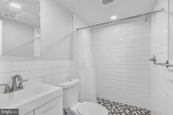 a bathroom with a shower toilet and sink