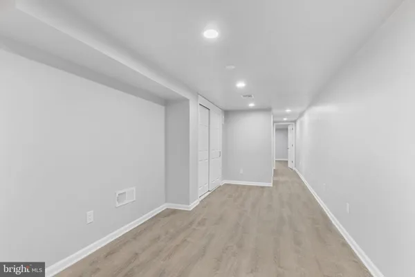 a view of hallway with wooden floor