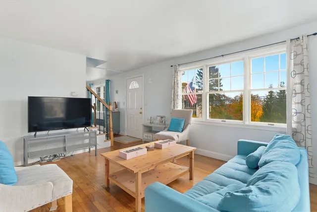 a view of entryway with wooden floor and stairs