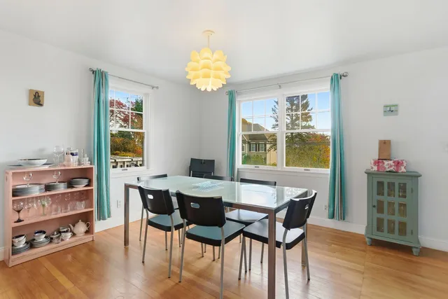 a kitchen with a table chairs microwave and cabinets