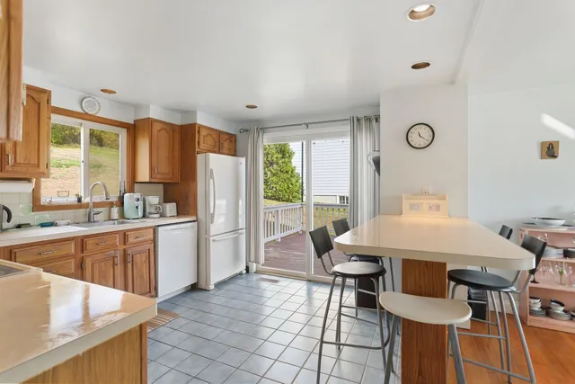 a kitchen with refrigerator and cabinets