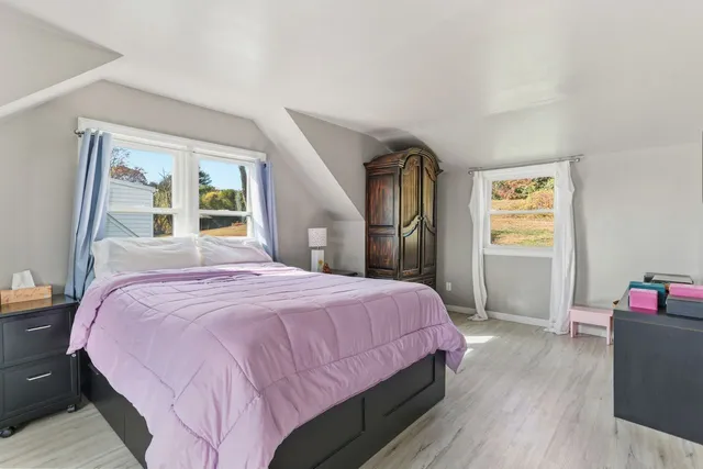 a bedroom with furniture and a closet