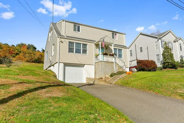 a front view of a house with a yard