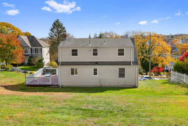 a view of a house with a backyard and a garden