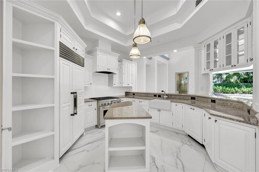 699 Fairway Terrace Naples, FL 34103 - Photo 11 of 46 a large white kitchen with lots of counter space and a sink