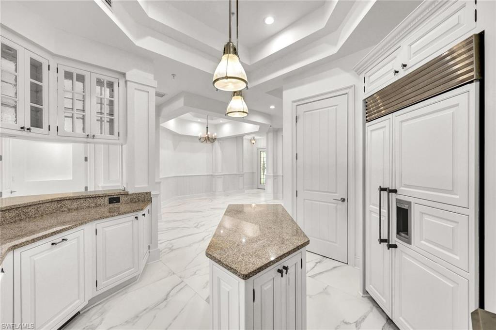 699 Fairway Terrace Naples, FL 34103 - Photo 12 of 46 a bathroom with a granite countertop sink a mirror and vanity