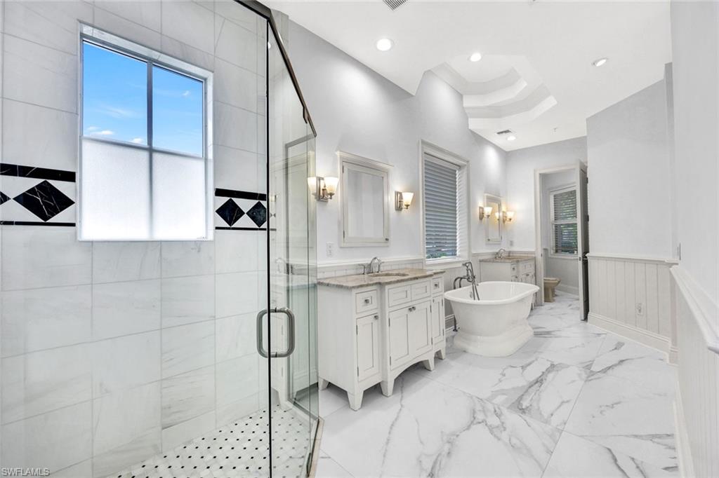 699 Fairway Terrace Naples, FL 34103 - Photo 20 of 46 a bathroom with a granite countertop sink a toilet a mirror and shower