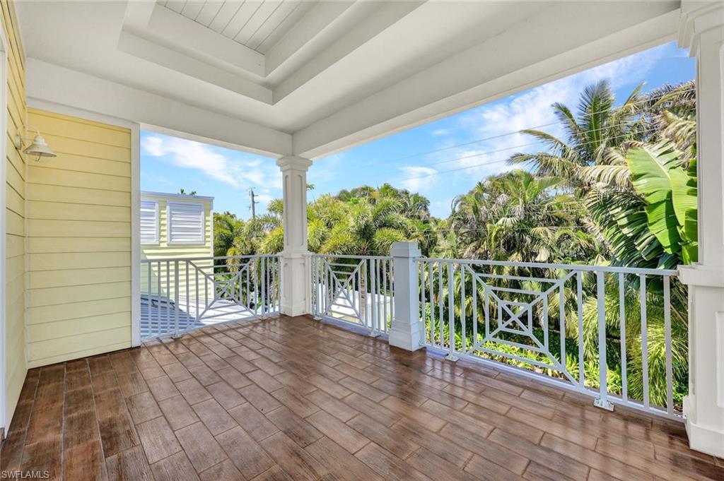 699 Fairway Terrace Naples, FL 34103 - Photo 34 of 46 a view of a porch with wooden floor