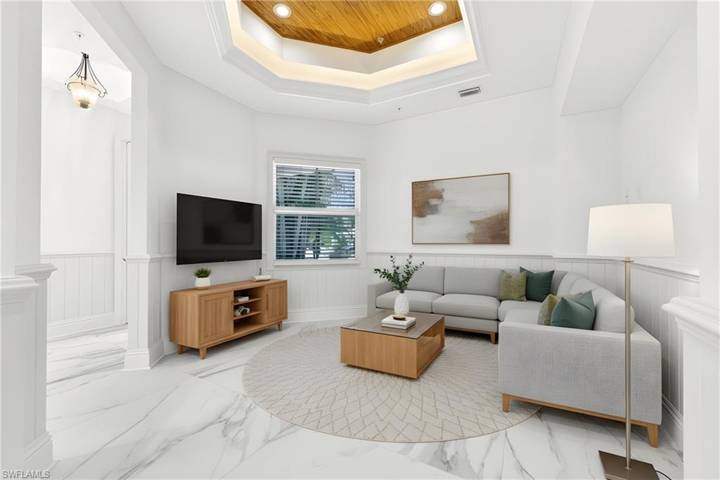 699 Fairway Terrace Naples, FL 34103 - Photo 10 of 46 a living room with furniture and a flat screen tv