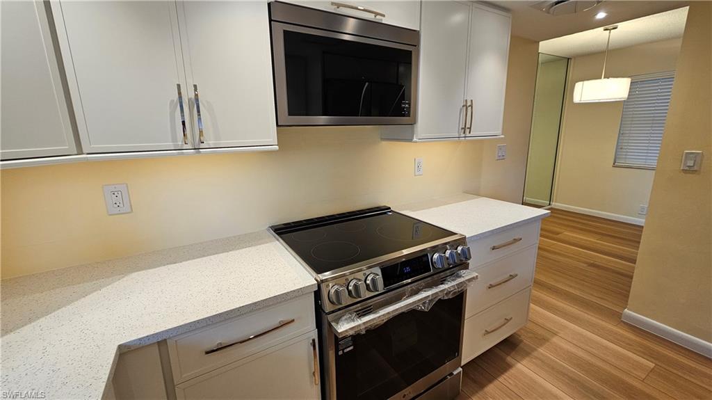 301 6th Avenue South, Unit D Naples, FL 34102 - Photo 11 of 29 Induction range and flush microwave