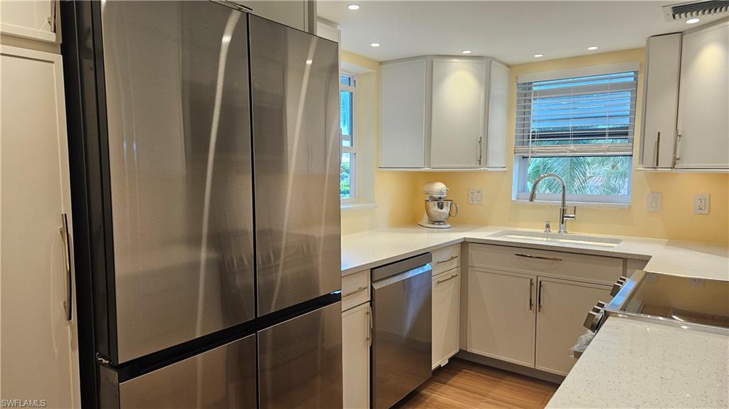 301 6th Avenue South, Unit D Naples, FL 34102 - Photo 13 of 29 View of Pantry, Refrigerator, cabinetry,dish washer, sing and cook top