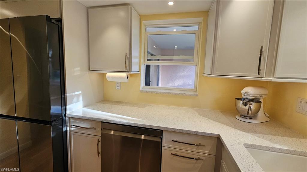 301 6th Avenue South, Unit D Naples, FL 34102 - Photo 15 of 29 Kitchen with counter tops and PASS-THROUGH WINDOW to Lanai