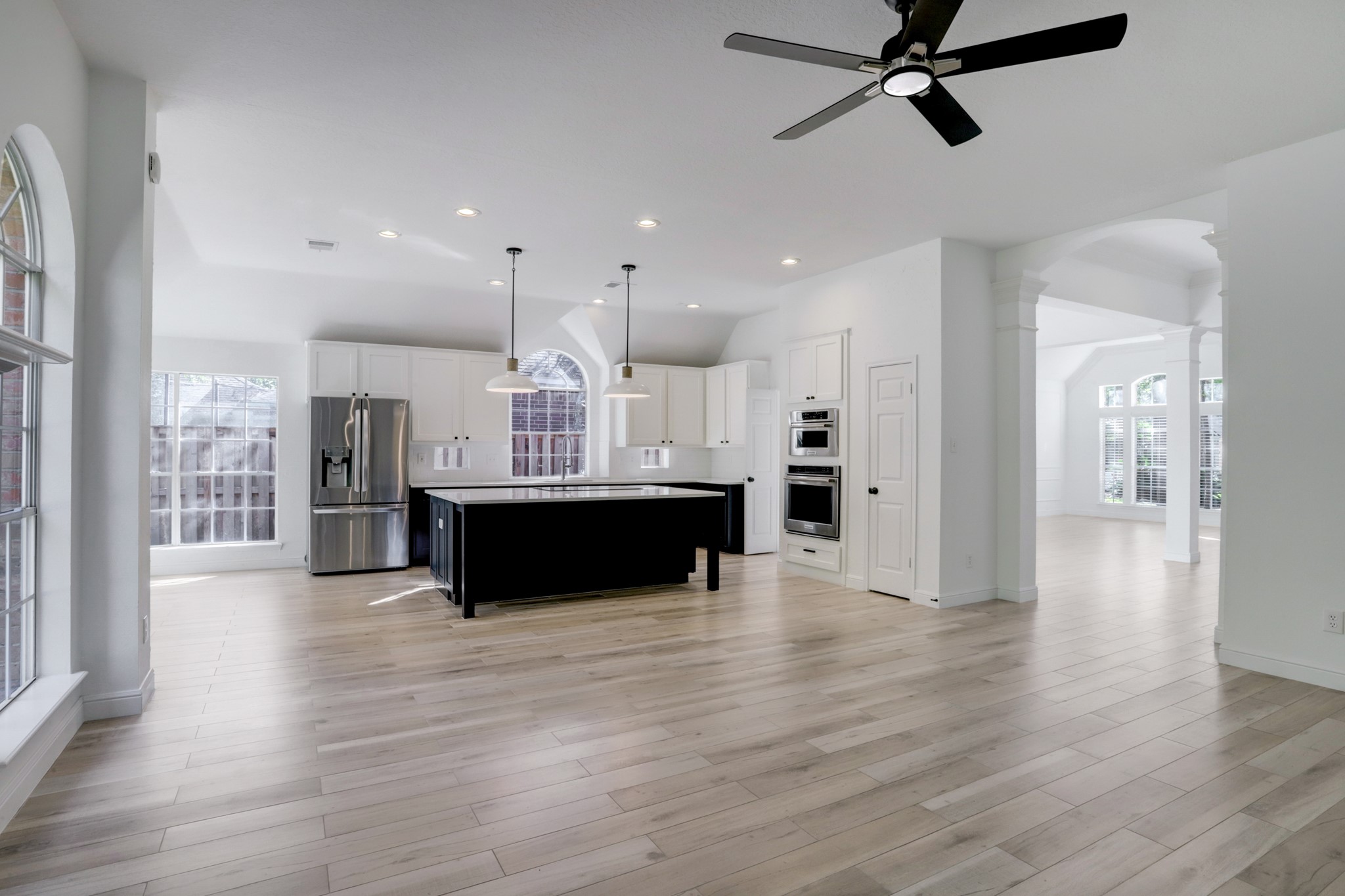 138 Summer Storm Place Spring, TX 77381 - Photo 9 of 20 Updated kitchen with contrasting cabinetry, quartz countertops, stainless steel appliances and an oversized island.