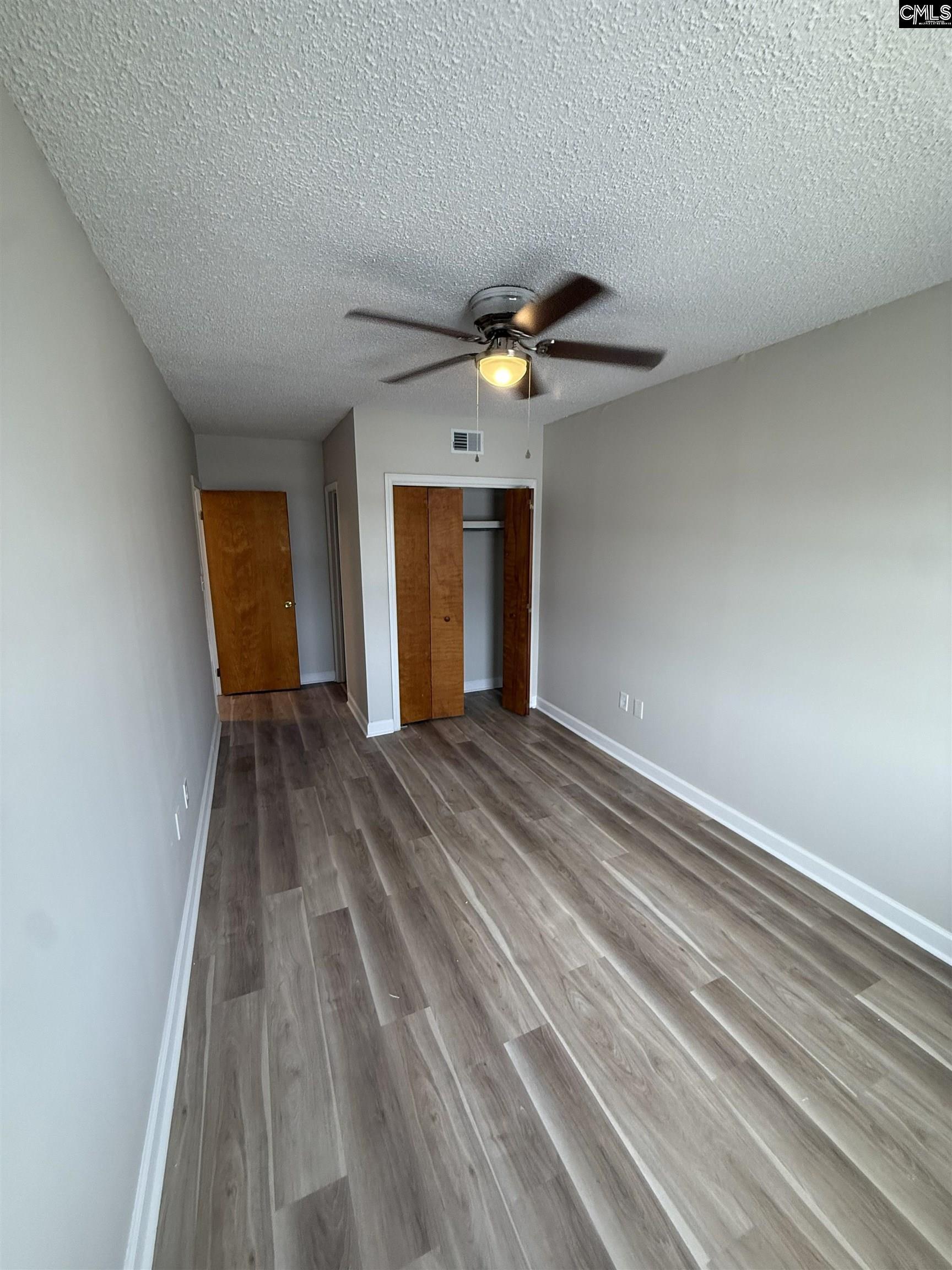 2002 Greene Street, Unit 209 Columbia, SC 29205 - Photo 19 of 22 wooden floor in an empty room with a window