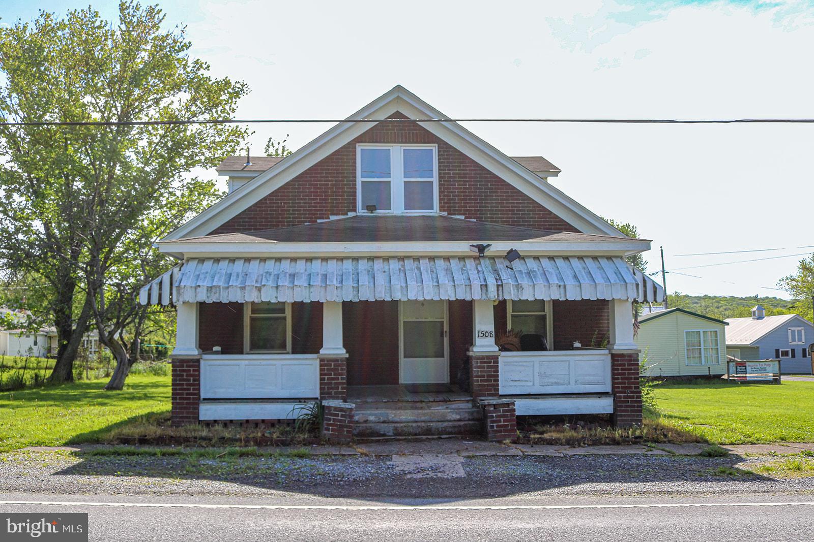 1508 Market Street Schellsburg, PA 15559 - Photo 1 of 24 a front view of a house with garden