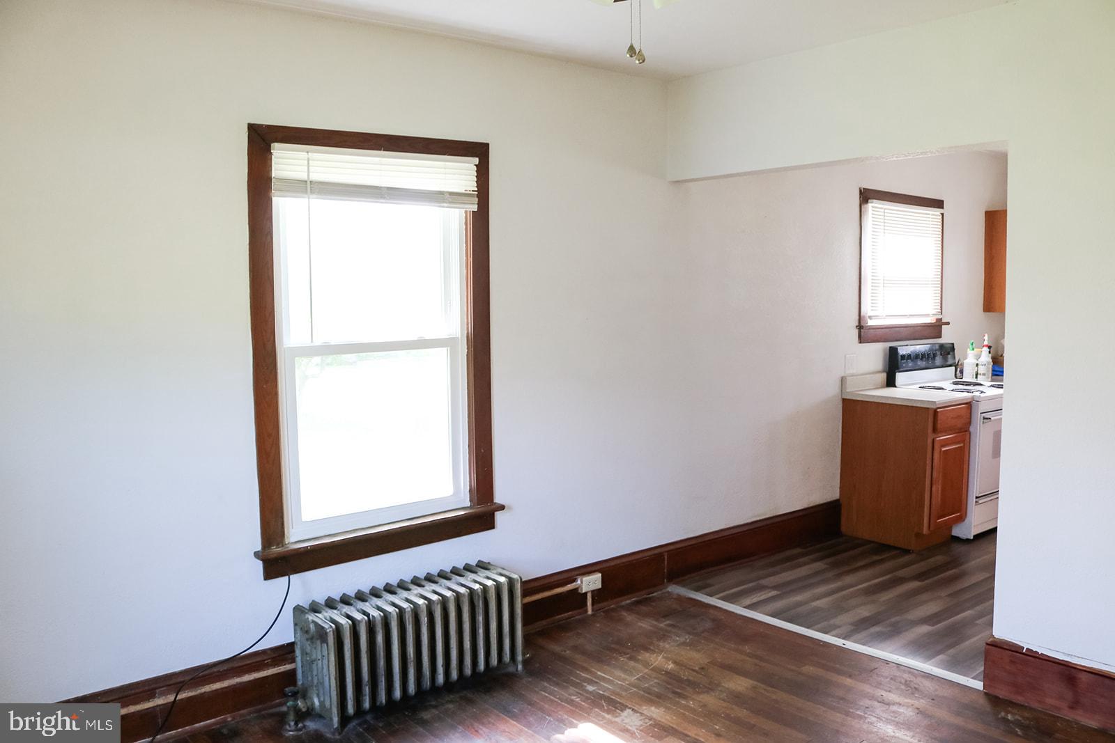 1508 Market Street Schellsburg, PA 15559 - Photo 11 of 24 a view of an empty room with wooden floor and a window