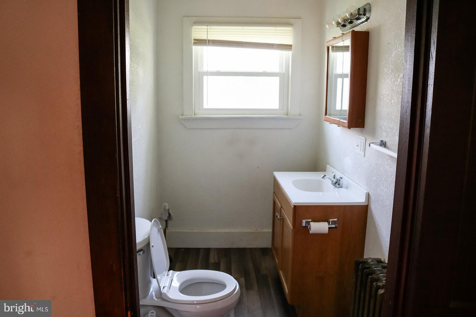 1508 Market Street Schellsburg, PA 15559 - Photo 13 of 24 a bathroom with a toilet sink and mirror