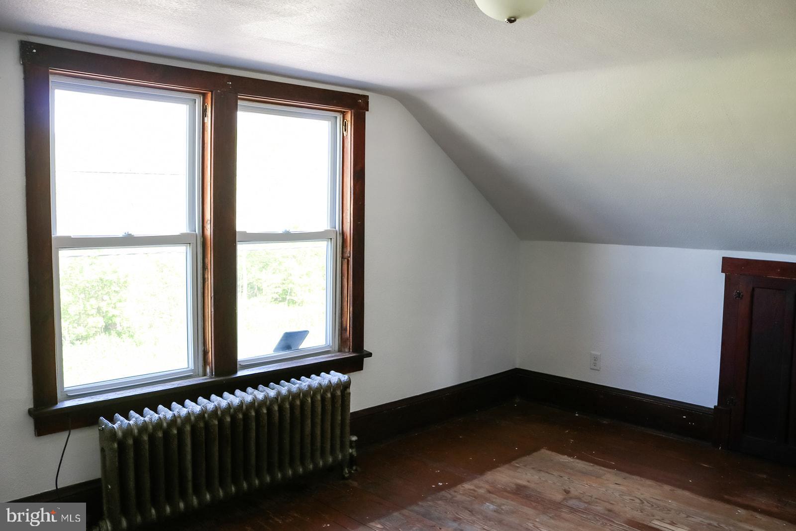 1508 Market Street Schellsburg, PA 15559 - Photo 22 of 24 a view of an empty room with wooden floor and a window