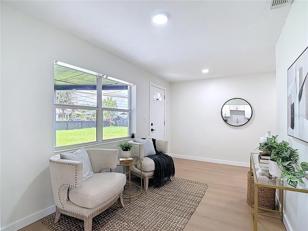 2402 East 148th Avenue Lutz, FL 33549 - Photo 16 of 71 a living room with furniture and a window