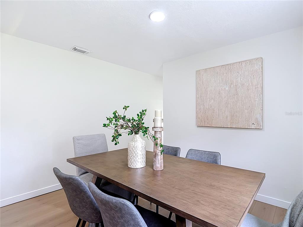 2402 East 148th Avenue Lutz, FL 33549 - Photo 23 of 71 a view of a dining room with a table and chair
