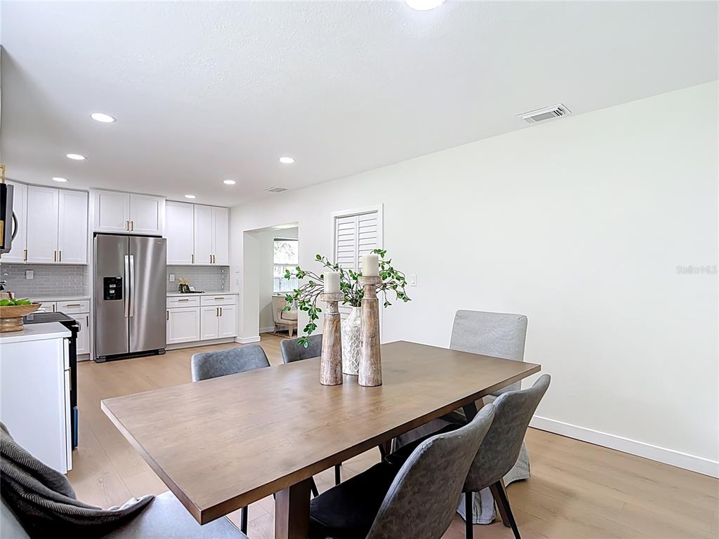 2402 East 148th Avenue Lutz, FL 33549 - Photo 24 of 71 a view of a dining room with furniture and a potted plant