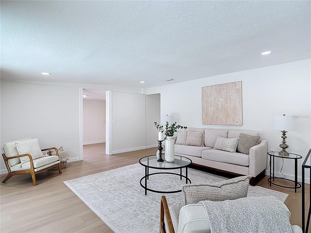 2402 East 148th Avenue Lutz, FL 33549 - Photo 29 of 71 a living room with furniture and wooden floor