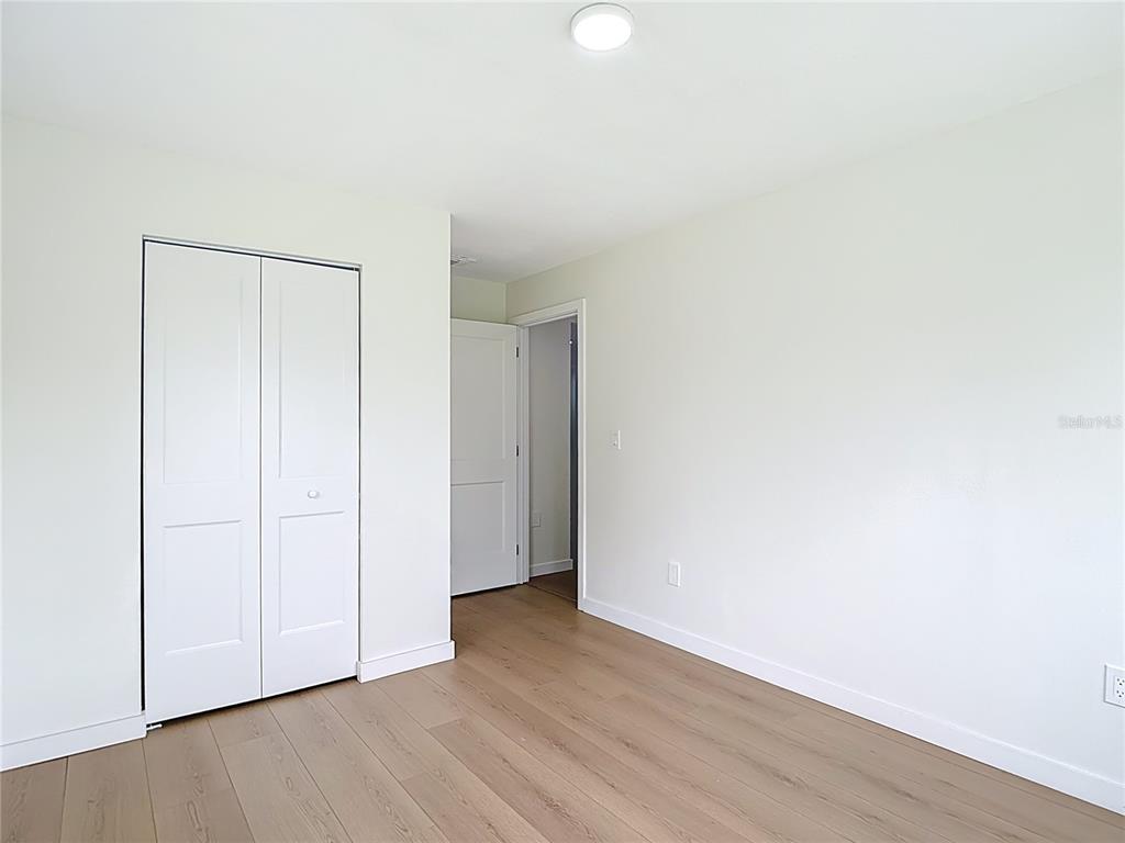2402 East 148th Avenue Lutz, FL 33549 - Photo 32 of 71 a view of an empty room with wooden floor