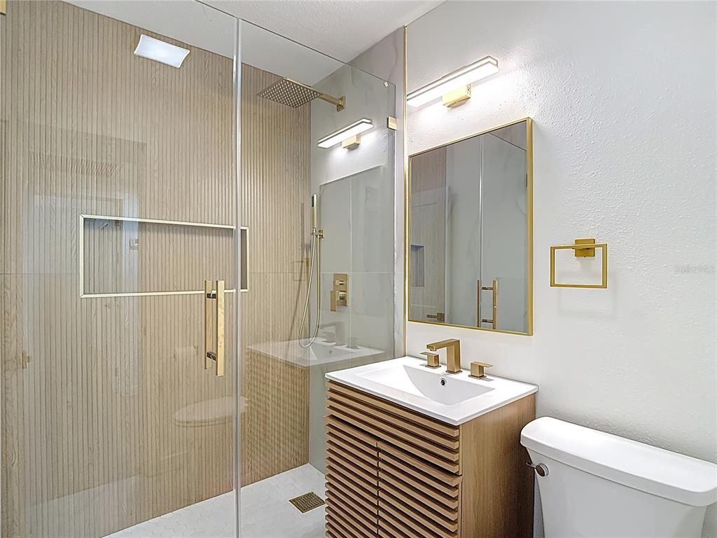 2402 East 148th Avenue Lutz, FL 33549 - Photo 44 of 71 a bathroom with a sink a toilet and shower