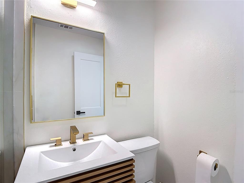 2402 East 148th Avenue Lutz, FL 33549 - Photo 45 of 71 a bathroom with a sink and a toilet