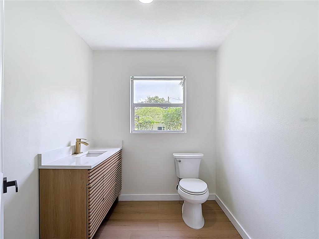 2402 East 148th Avenue Lutz, FL 33549 - Photo 51 of 71 a bathroom with a toilet a sink and a window
