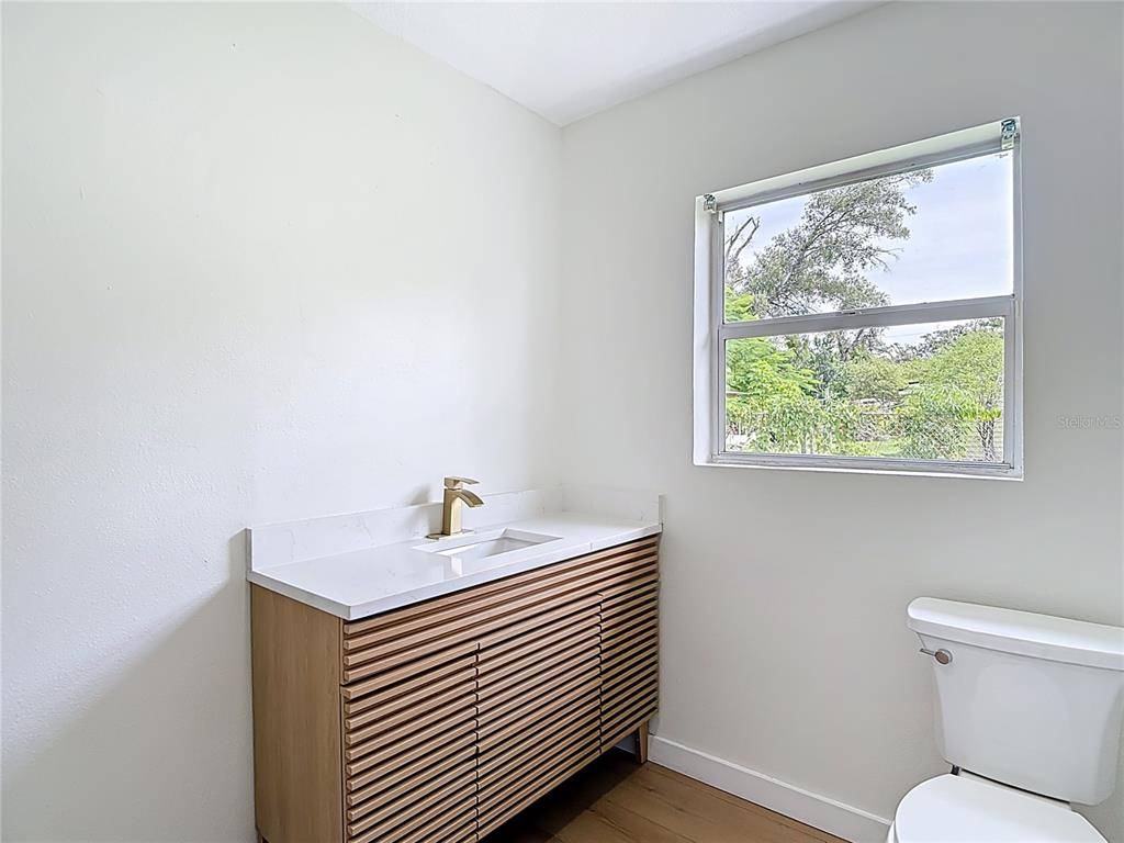 2402 East 148th Avenue Lutz, FL 33549 - Photo 52 of 71 a bathroom with a sink a toilet and a window