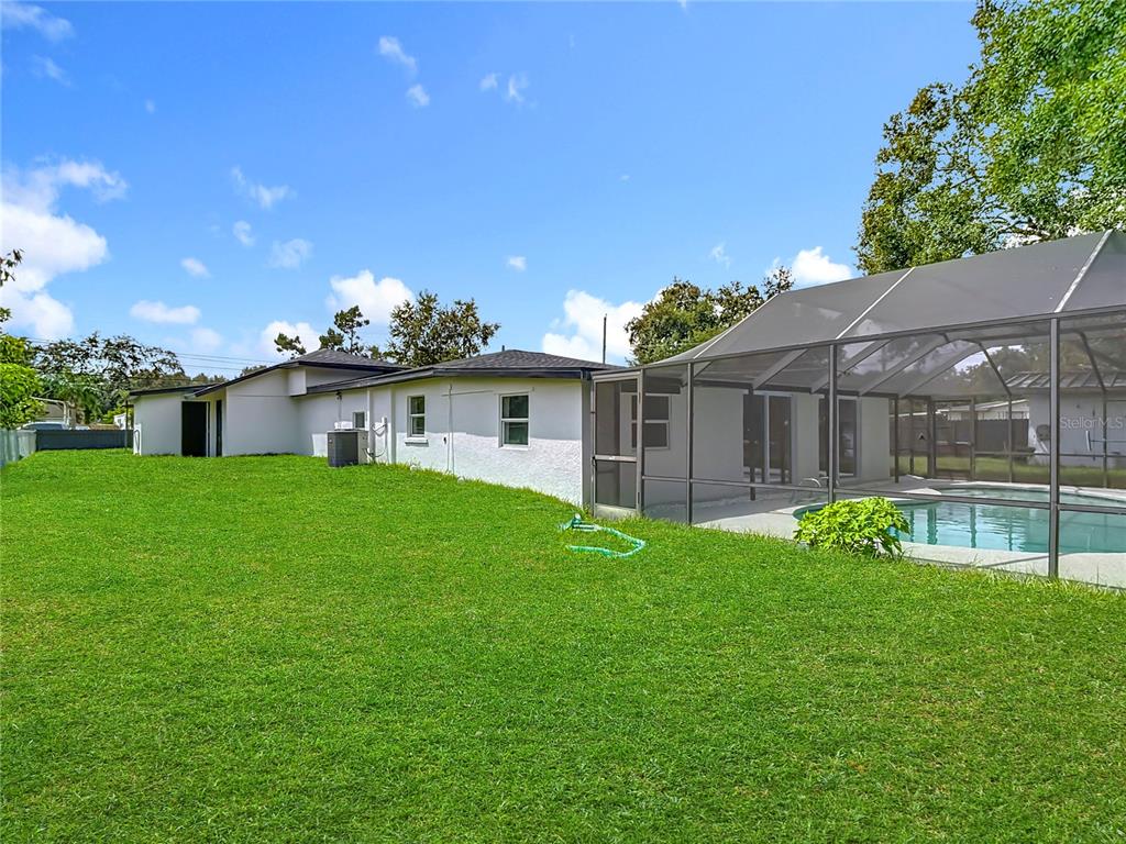 2402 East 148th Avenue Lutz, FL 33549 - Photo 58 of 71 a front view of house with yard and green space