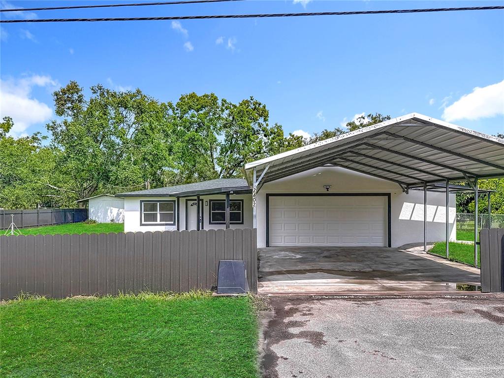 2402 East 148th Avenue Lutz, FL 33549 - Photo 62 of 71 a front view of a house with a yard and garage