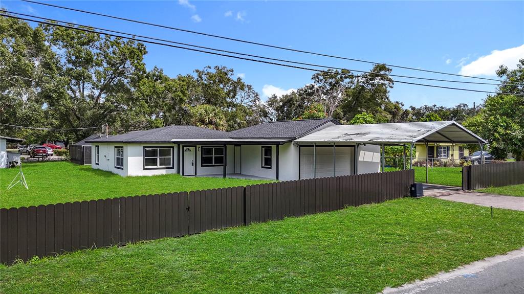 2402 East 148th Avenue Lutz, FL 33549 - Photo 8 of 71 a front view of a house with a yard