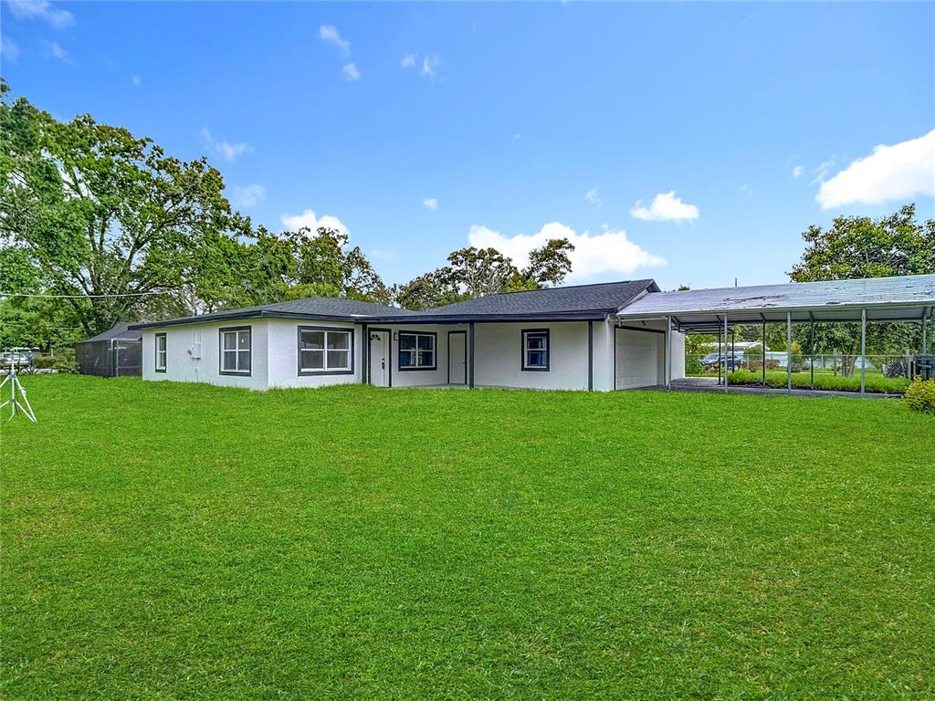 2402 East 148th Avenue Lutz, FL 33549 - Photo 10 of 71 a front view of house with yard and green space
