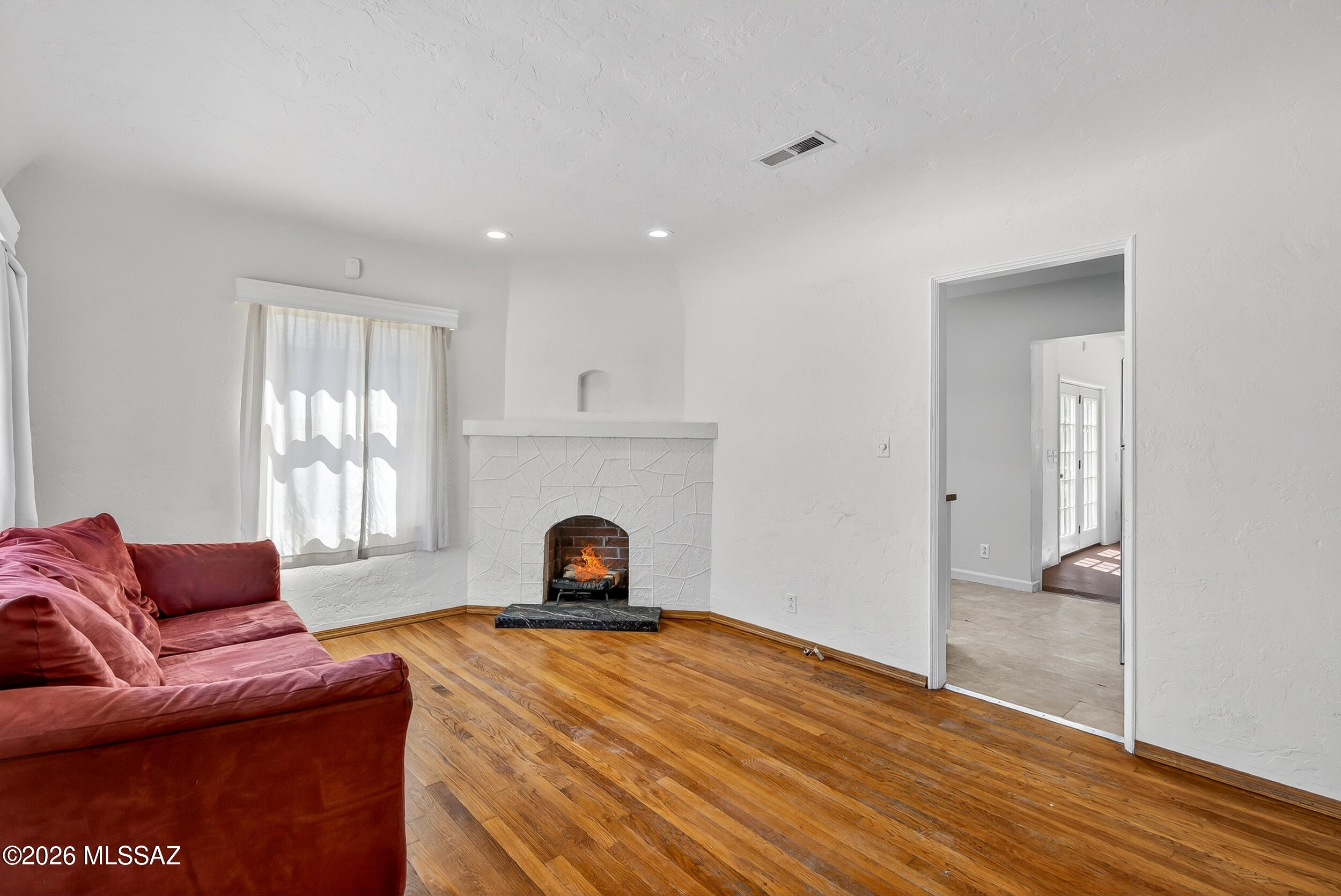 1412 East Spring Street Tucson, AZ 85719 - Photo 14 of 43 a living room with furniture a fireplace and a window
