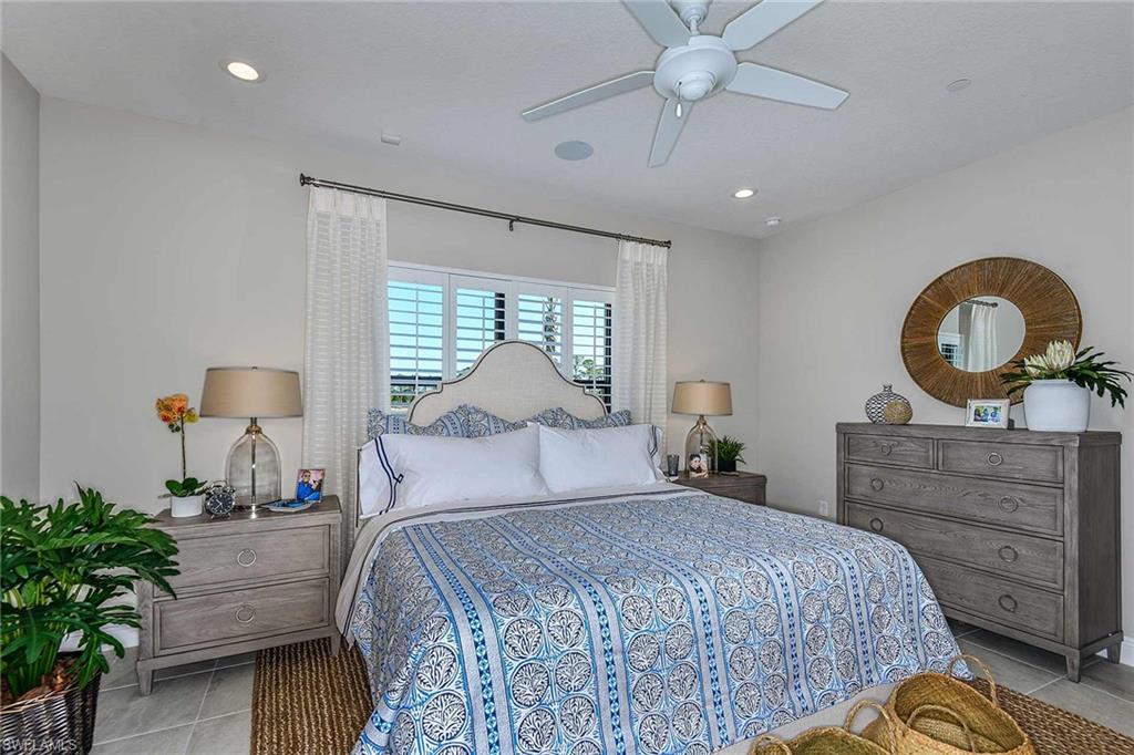4671 Centaurus Circle Naples, FL 34120 - Photo 13 of 21 a bedroom with a bed and a chandelier