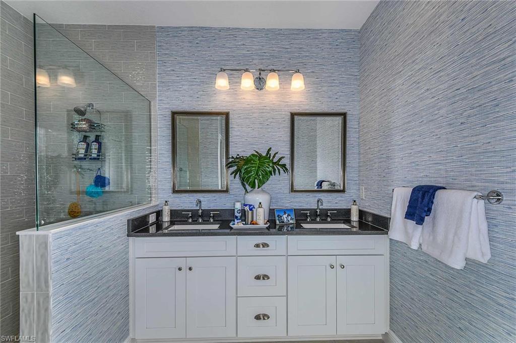 4671 Centaurus Circle Naples, FL 34120 - Photo 14 of 21 a bathroom with a double vanity sink and a mirror