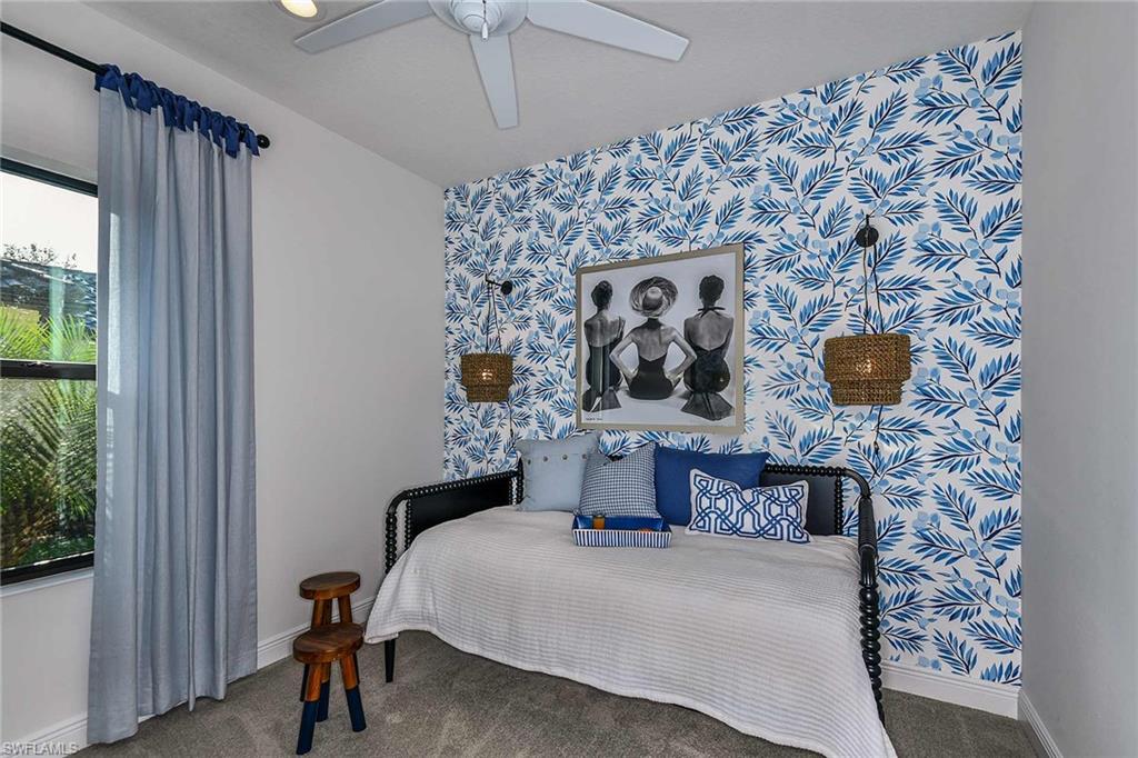 4671 Centaurus Circle Naples, FL 34120 - Photo 16 of 21 a bedroom with a bed and a chair with the bookshelf