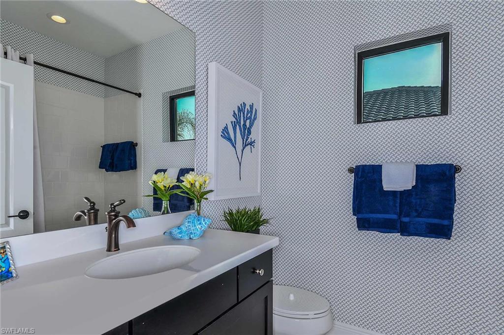 4671 Centaurus Circle Naples, FL 34120 - Photo 17 of 21 a bathroom with a sink toilet and mirror