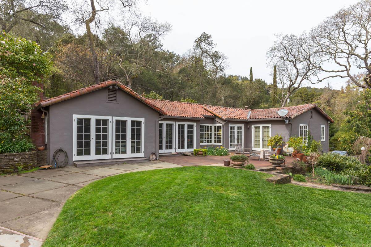 1475 Portola Road Woodside, CA 94062 - Photo 1 of 12 a front view of a house with a yard and trees