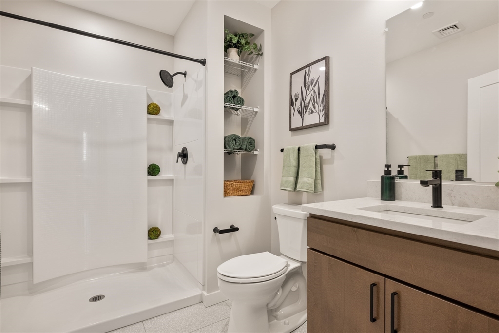 22 Elm Street, Unit 302 Worcester, MA 01608 - Photo 14 of 18 a bathroom with a sink toilet and shower