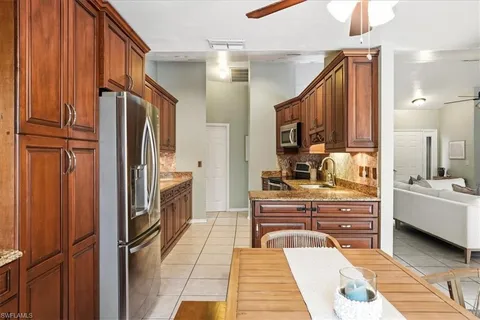 a kitchen with stainless steel appliances a refrigerator and a stove top oven