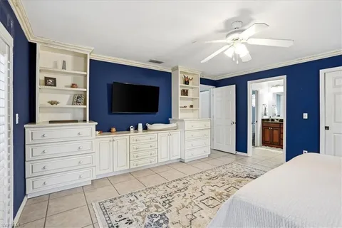 a bedroom with furniture and flat screen tv